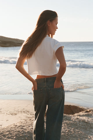 Women’s cropped T-shirt crafted from ultra-soft 100% organic cotton. Features high neckline, open sleeves and Sea_Washed blueprint and wave logos. Ethically made in Portugal and fully biodegradable.